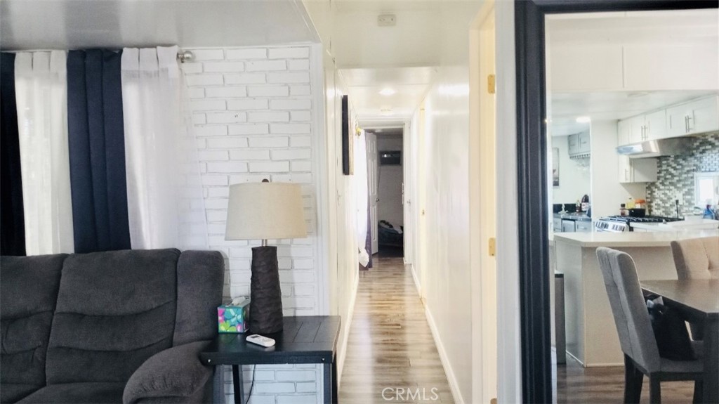 26250 9th Street, Unit 131 Highland, CA 92346 - Photo 5 of 15 a living room with furniture and a fireplace