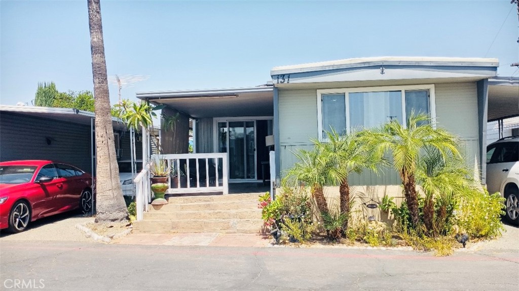 26250 9th Street, Unit 131 Highland, CA 92346 - Photo 7 of 15 a view of a house with a cars park front of a road