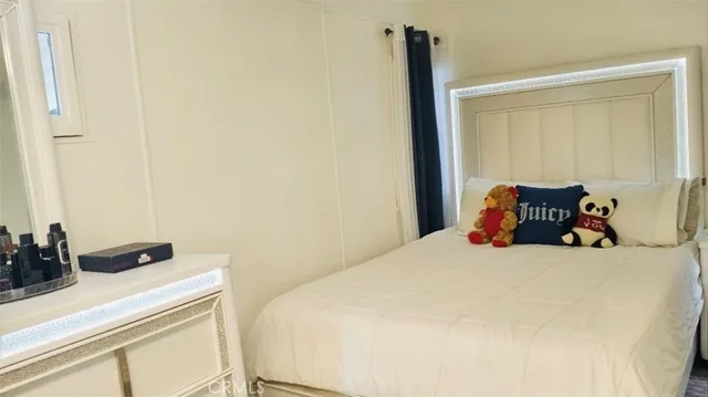 a bedroom with a bed and hallway