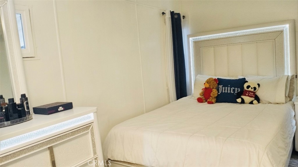 26250 9th Street, Unit 131 Highland, CA 92346 - Photo 10 of 15 a bedroom with a bed and wooden floor