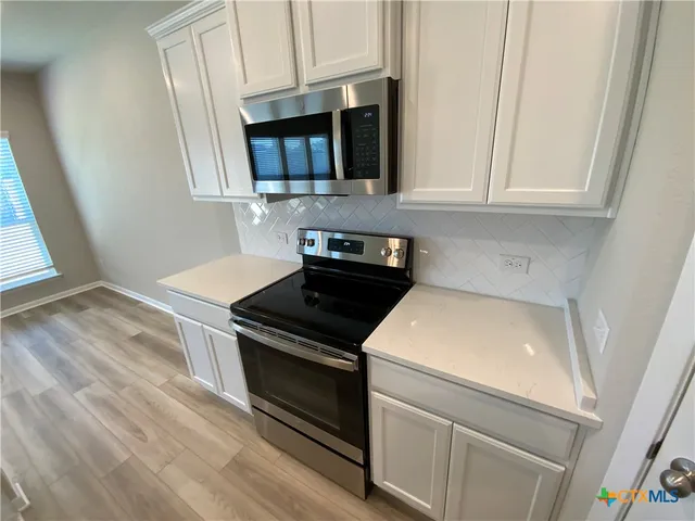 a kitchen with a stove and a microwave