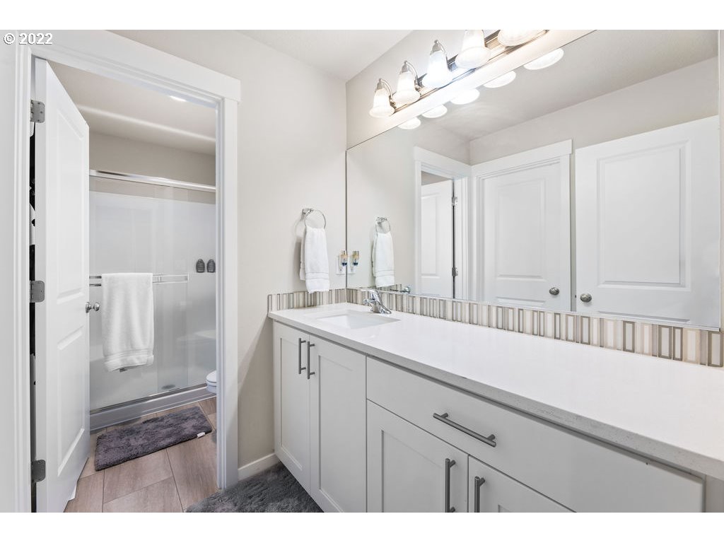 2620 South 12th Court Ridgefield, WA 98642 - Photo 13 of 20 a bathroom with a sink a mirror and a shower