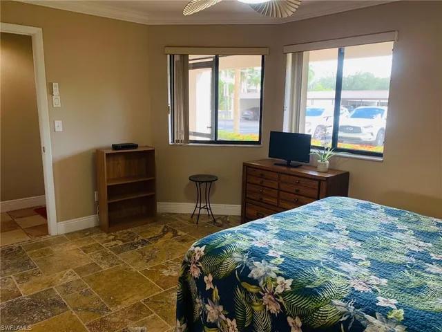 a bedroom with a bed and a desk