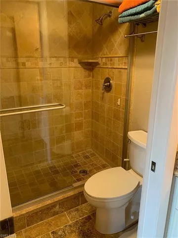 a bathroom with a toilet and a shower