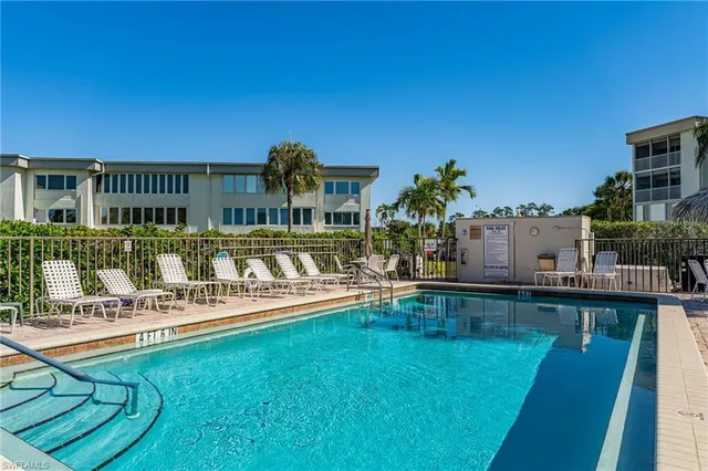 a view of a house with pool and sitting area