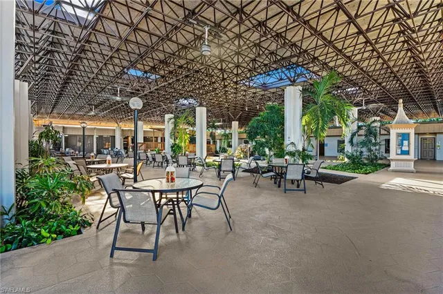 a view of a patio with table and chairs under an umbrella