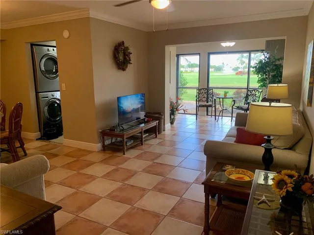 a living room with furniture and a floor to ceiling window