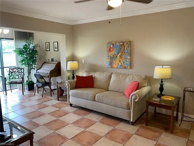 a living room with furniture and a potted plant