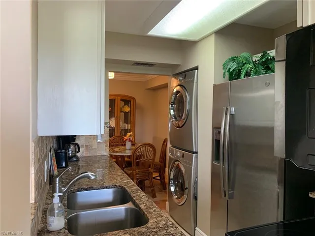 a room with water heater and refrigerator