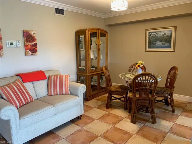 a living room with furniture and a dining table