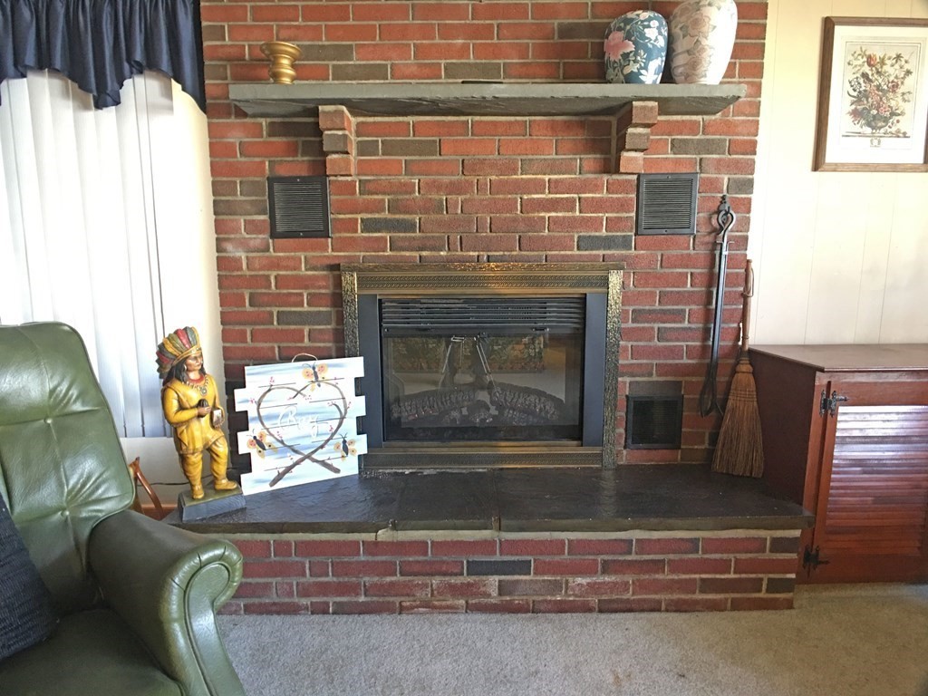 71 Kennedy Street Fall River, MA 02721 - Photo 13 of 28 a living room with furniture and a fireplace