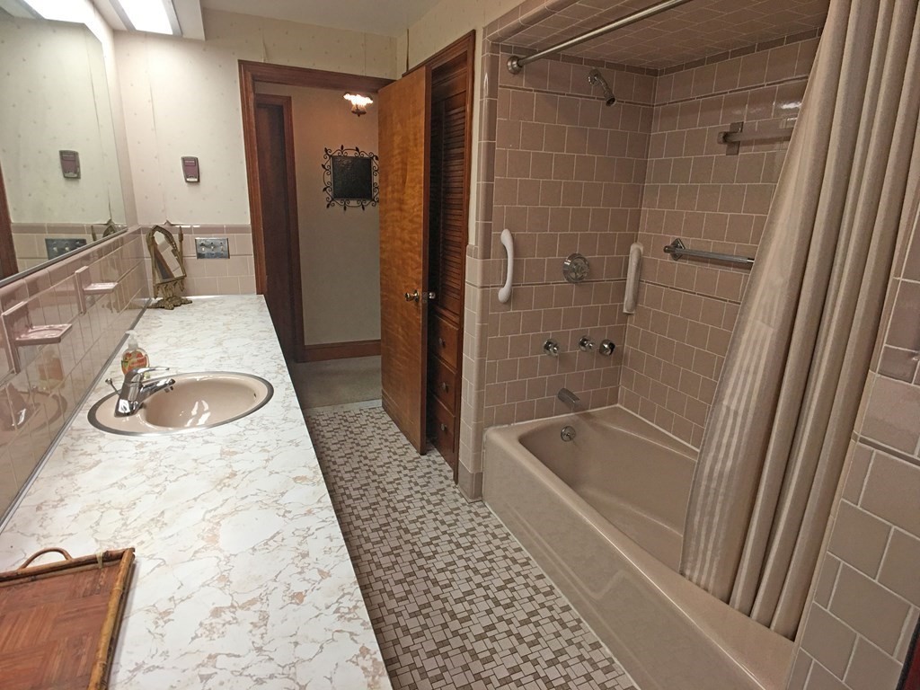 71 Kennedy Street Fall River, MA 02721 - Photo 14 of 28 a bathroom with a granite countertop sink a toilet and shower