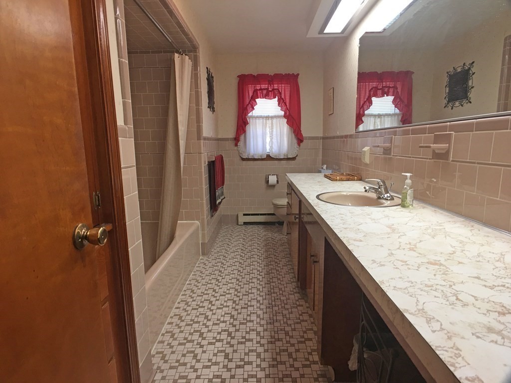 71 Kennedy Street Fall River, MA 02721 - Photo 15 of 28 a bathroom with a granite countertop sink and a mirror