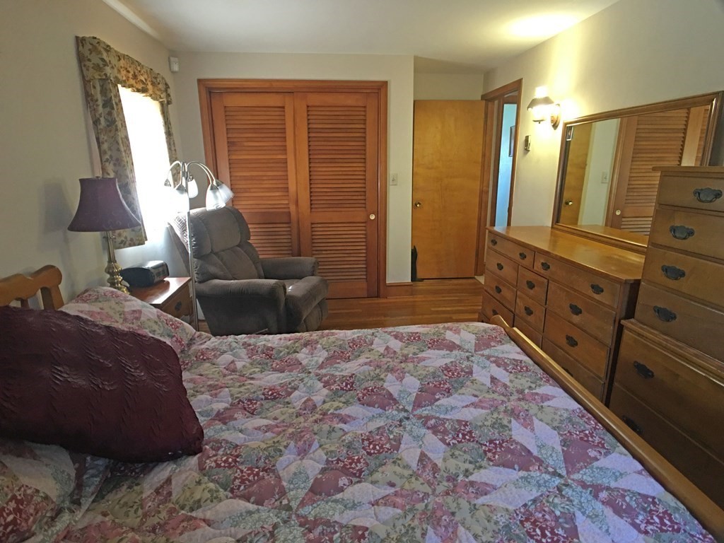 71 Kennedy Street Fall River, MA 02721 - Photo 16 of 28 a spacious bedroom with a bed and wooden floor