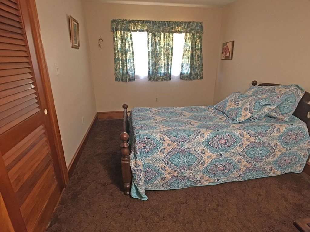 71 Kennedy Street Fall River, MA 02721 - Photo 18 of 28 a bed sitting in a bedroom next to a window