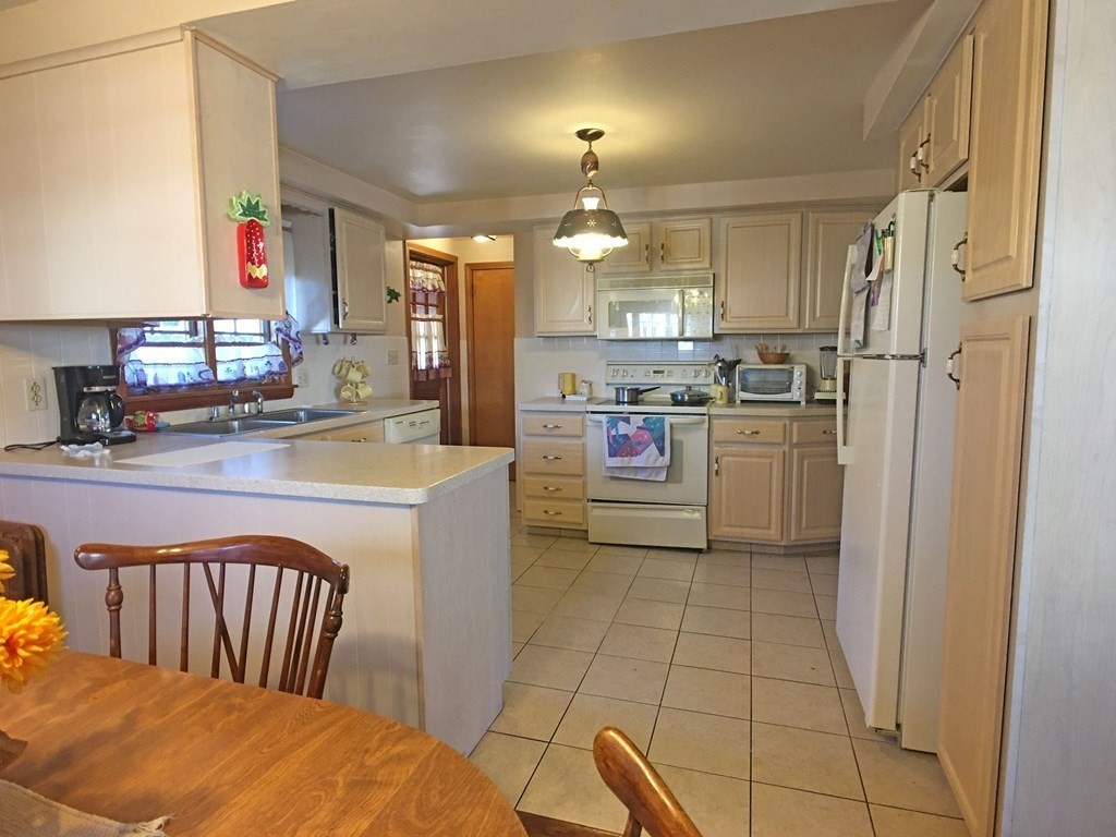 71 Kennedy Street Fall River, MA 02721 - Photo 7 of 28 a kitchen with refrigerator and cabinets