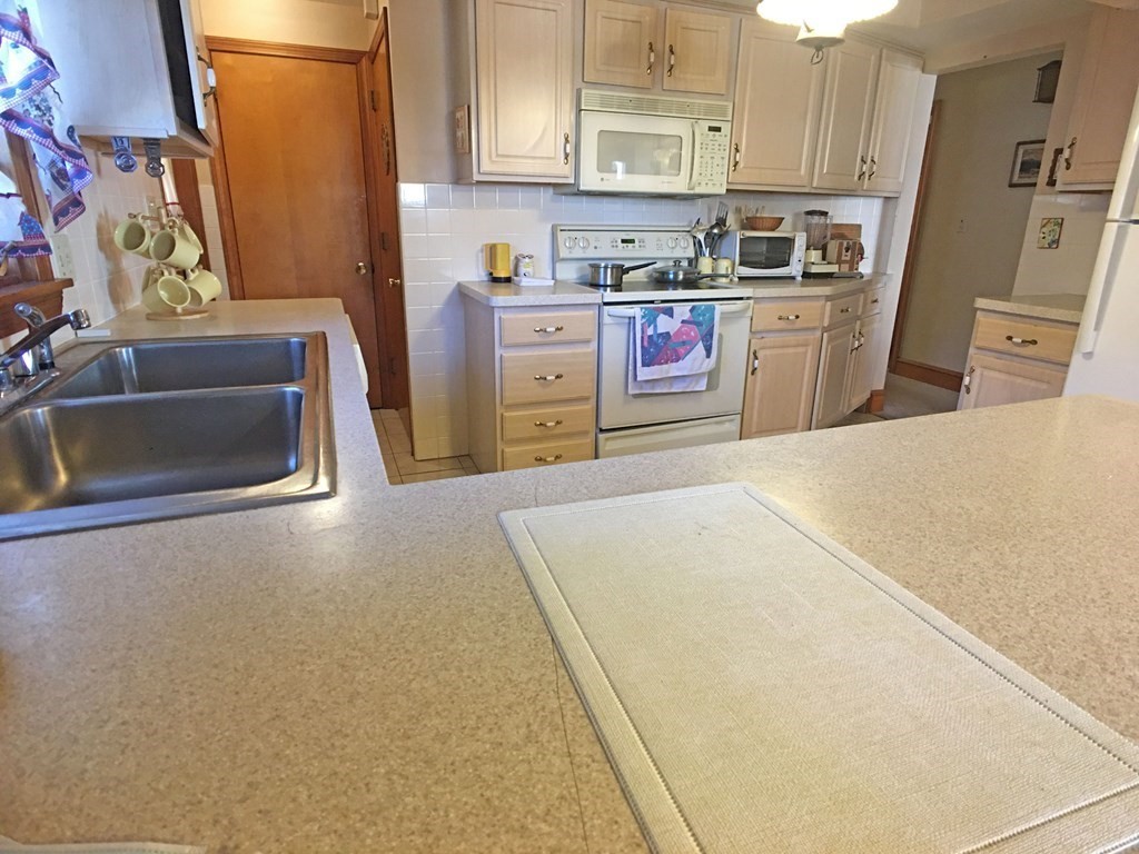 71 Kennedy Street Fall River, MA 02721 - Photo 10 of 28 a kitchen with stainless steel appliances a stove a refrigerator a sink a stove and white cabinets