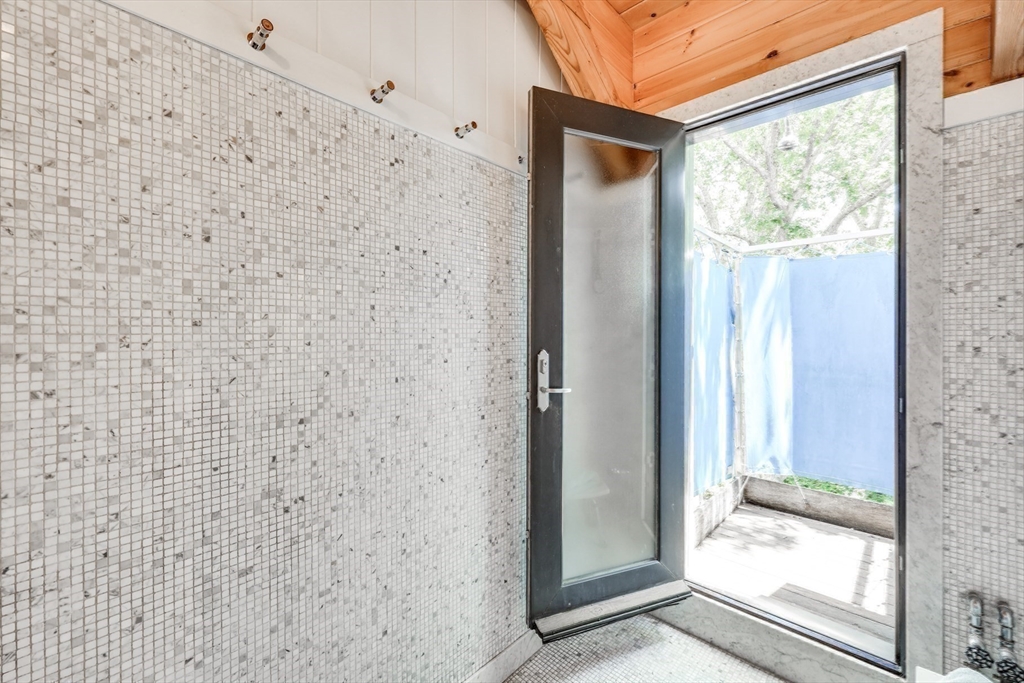 14-16 Sippewissett Road Falmouth, MA 02540 - Photo 25 of 39 a bathroom with a glass door and a shower