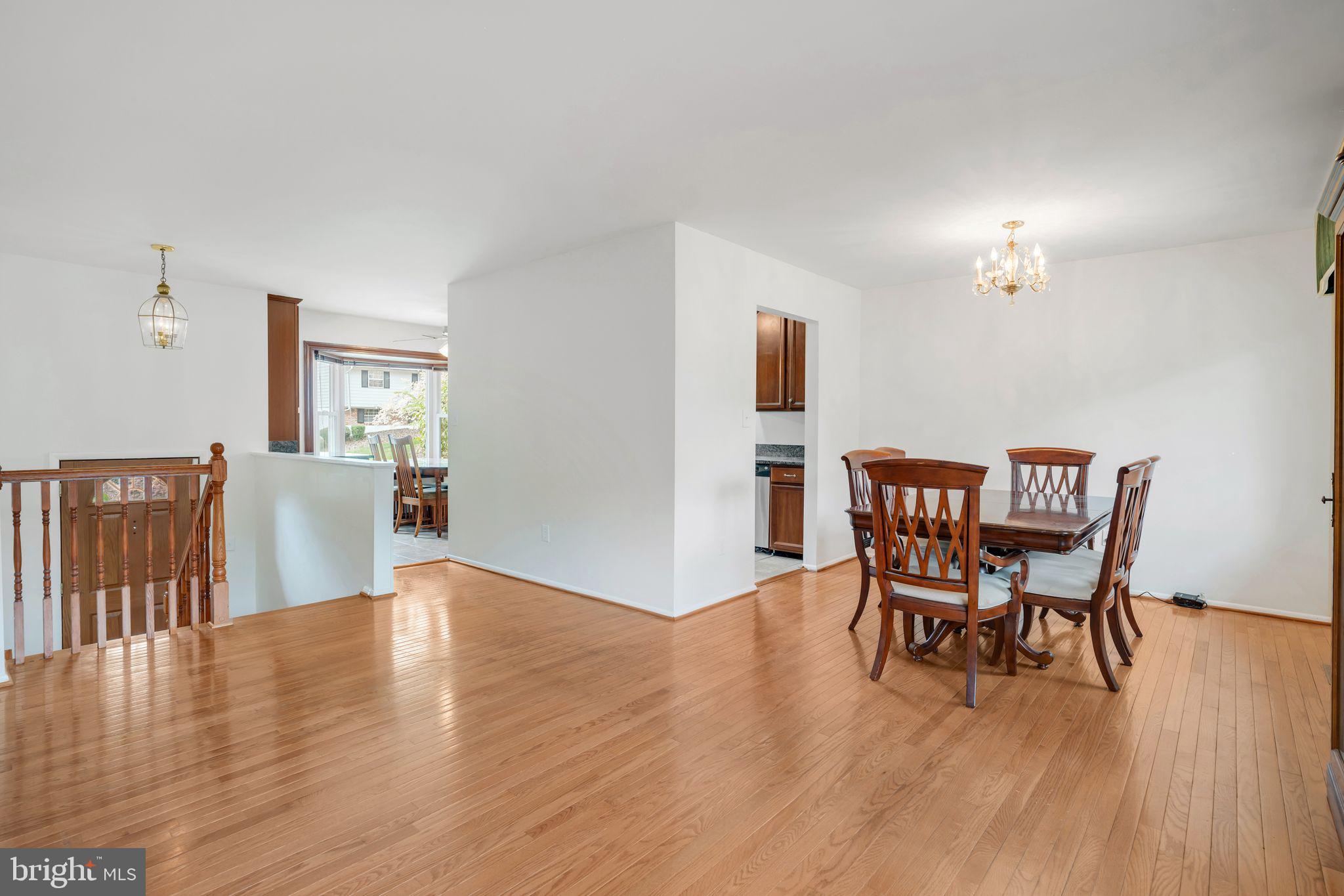 4552 Kinmount Road Lanham, MD 20706 - Photo 13 of 55 a view of a dining room with furniture and wooden floor