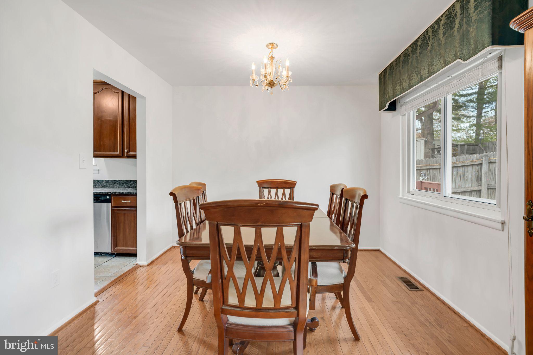 4552 Kinmount Road Lanham, MD 20706 - Photo 14 of 55 a view of a dining room with furniture window and wooden floor