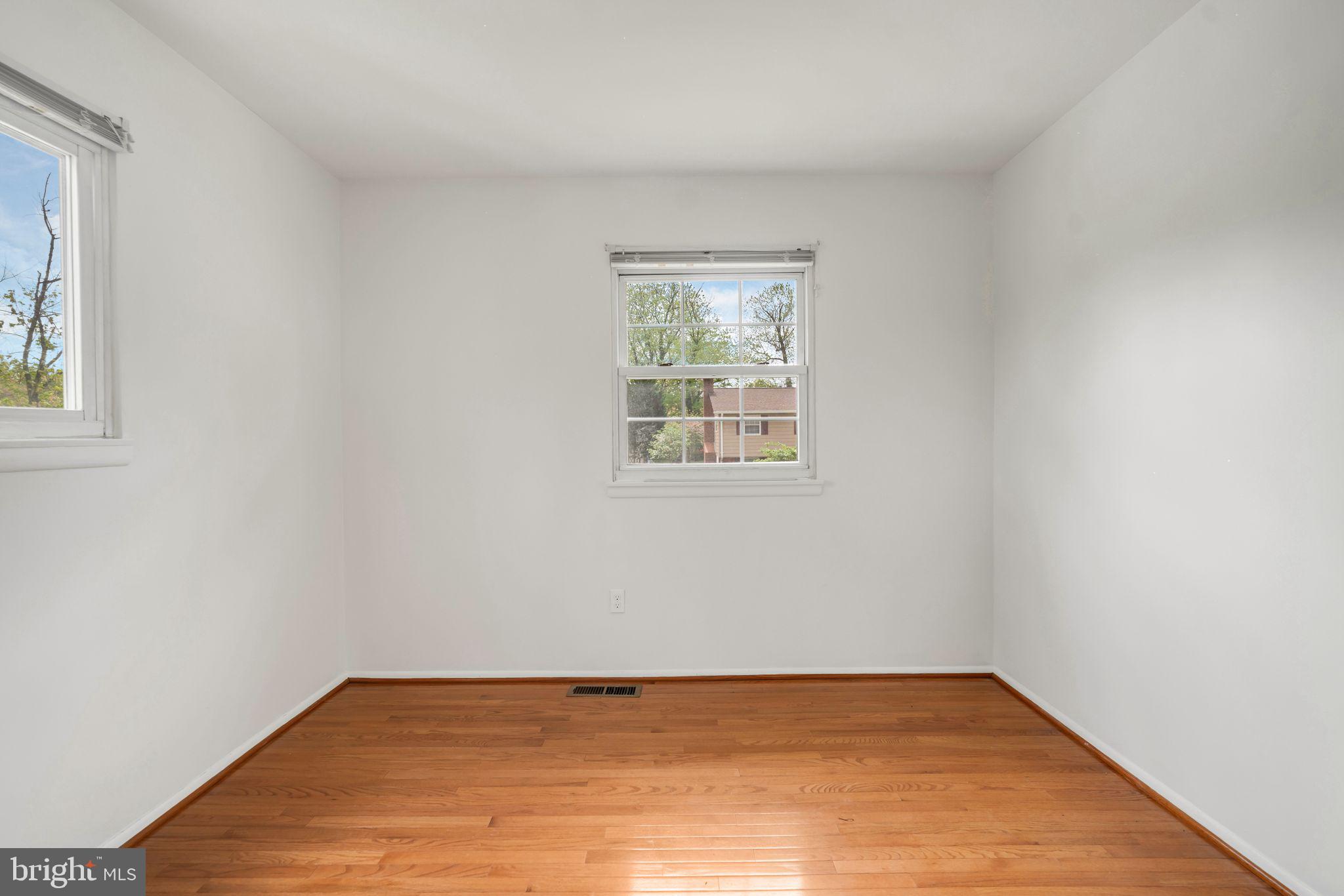 4552 Kinmount Road Lanham, MD 20706 - Photo 28 of 55 an empty room with wooden floor and windows