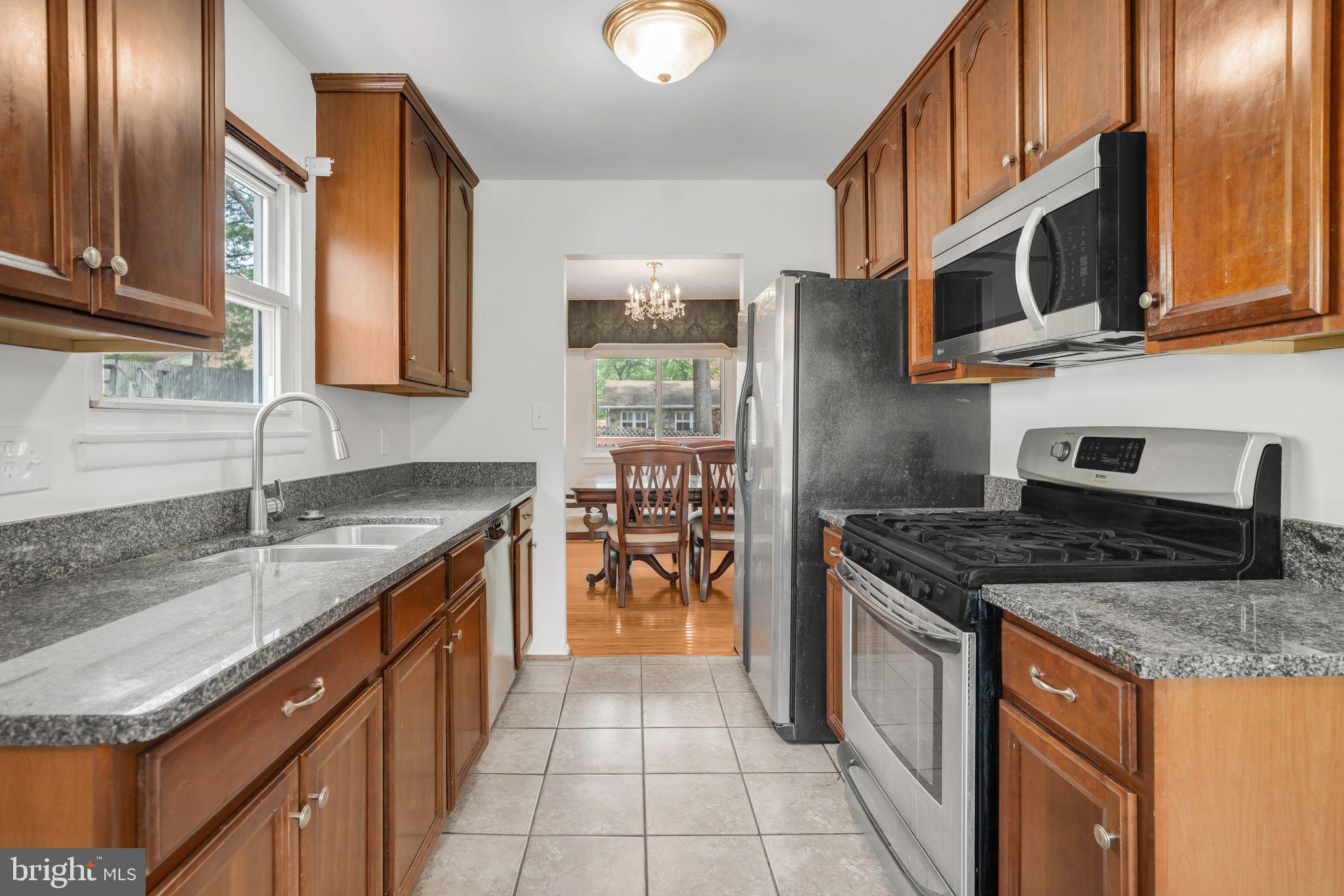 4552 Kinmount Road Lanham, MD 20706 - Photo 6 of 55 a kitchen with stainless steel appliances granite countertop a stove and a sink