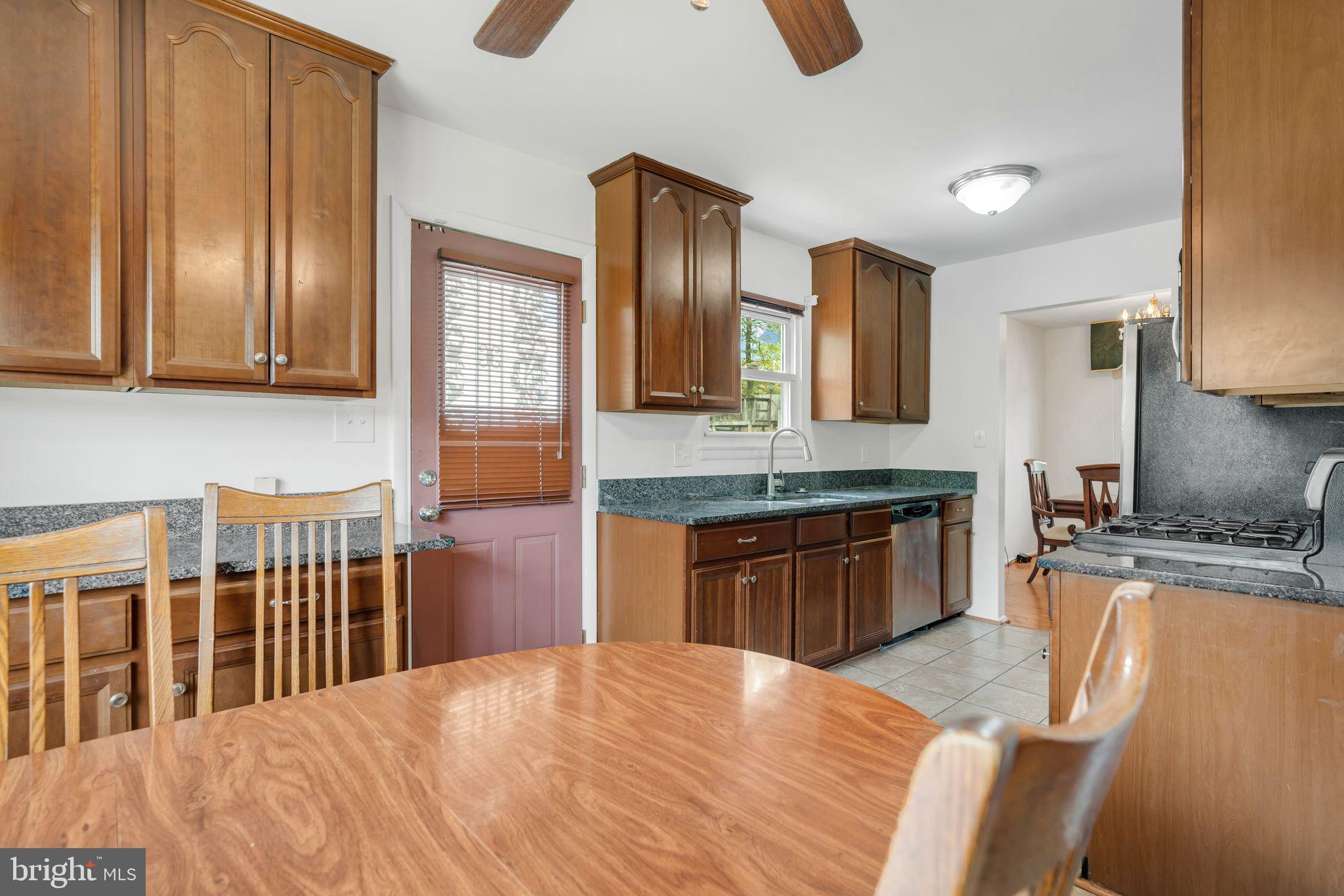 4552 Kinmount Road Lanham, MD 20706 - Photo 9 of 55 a kitchen with stainless steel appliances granite countertop a sink dishwasher stove and refrigerator