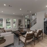 a living room with furniture a fireplace and a large window