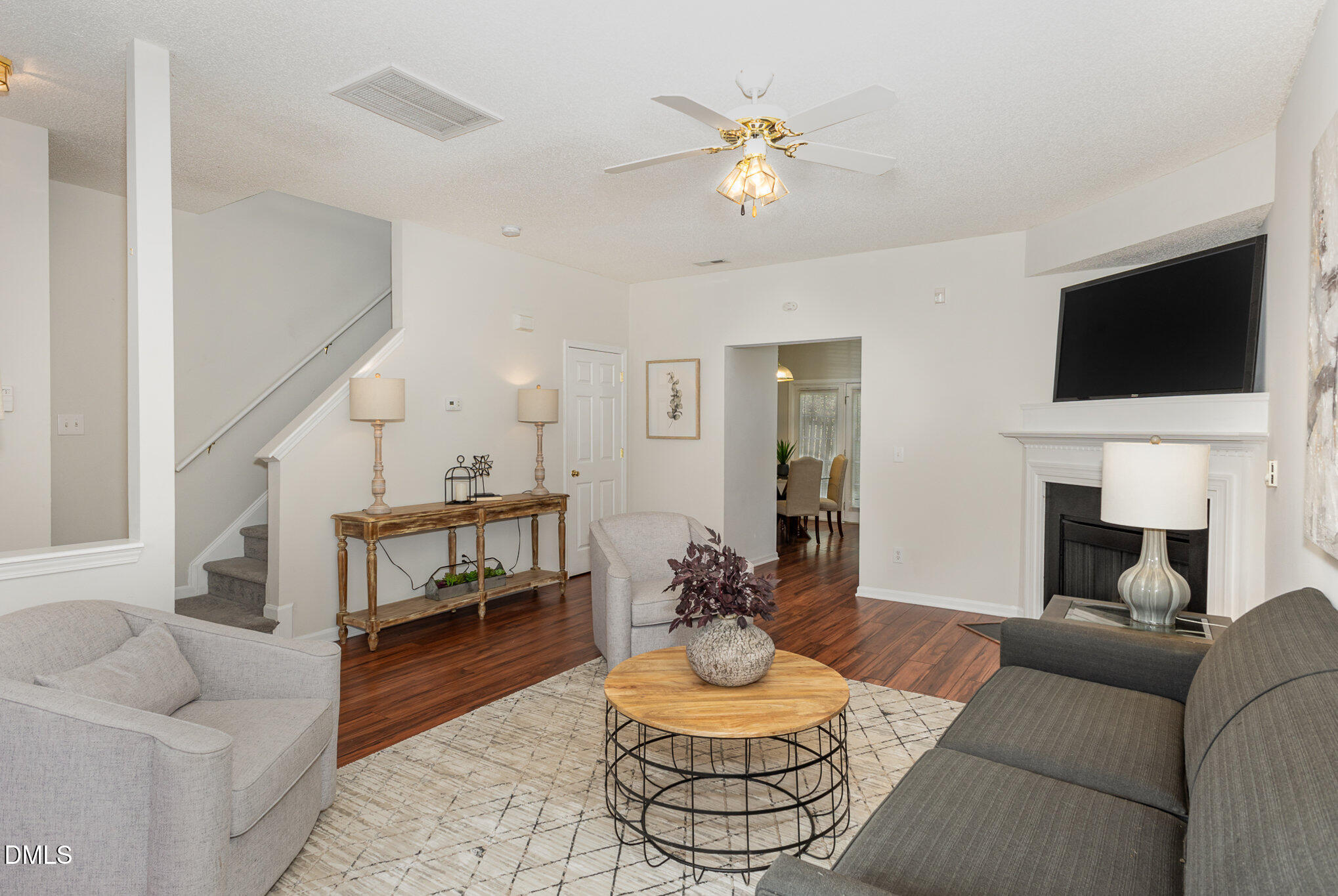 10947 Pendragon Place Raleigh, NC 27614 - Photo 6 of 21 a living room with furniture a fireplace and a flat screen tv