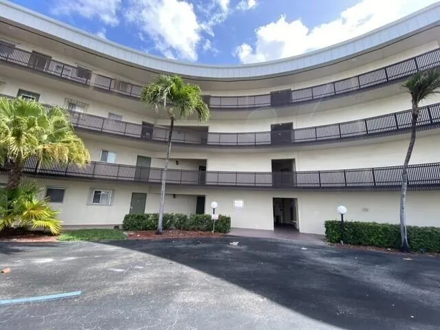 a front view of a building with a yard and garage