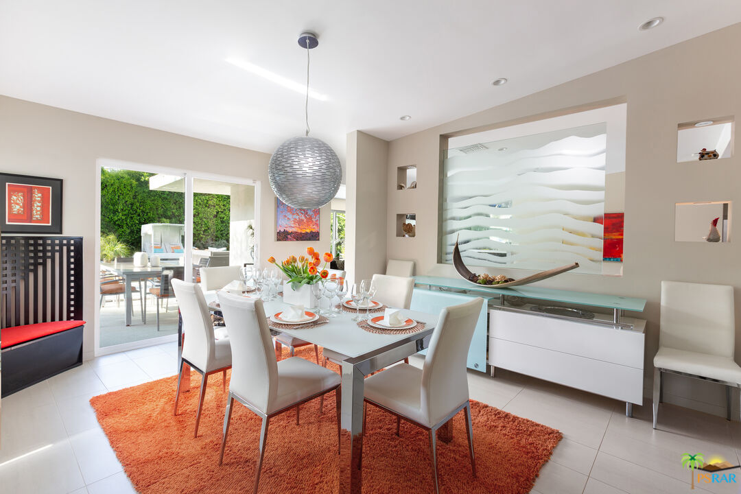 646 East Morongo Road Palm Springs, CA 92264 - Photo 14 of 45 a dining room with furniture a chandelier and wooden floor