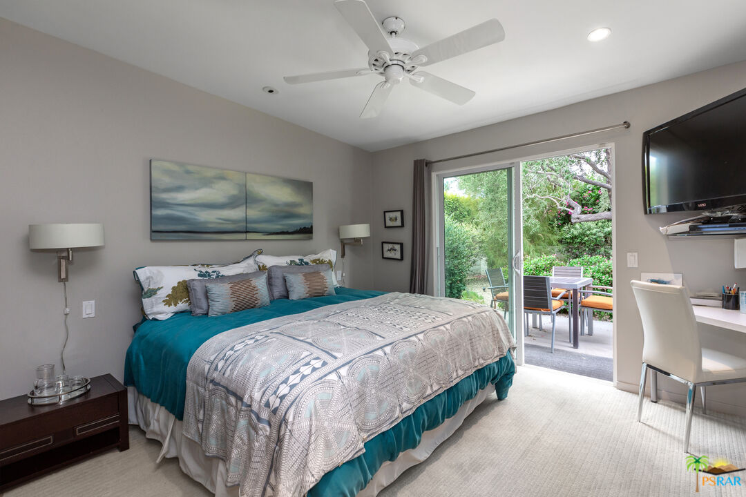 646 East Morongo Road Palm Springs, CA 92264 - Photo 17 of 45 a bedroom with a large bed and a flat tv screen on dresser