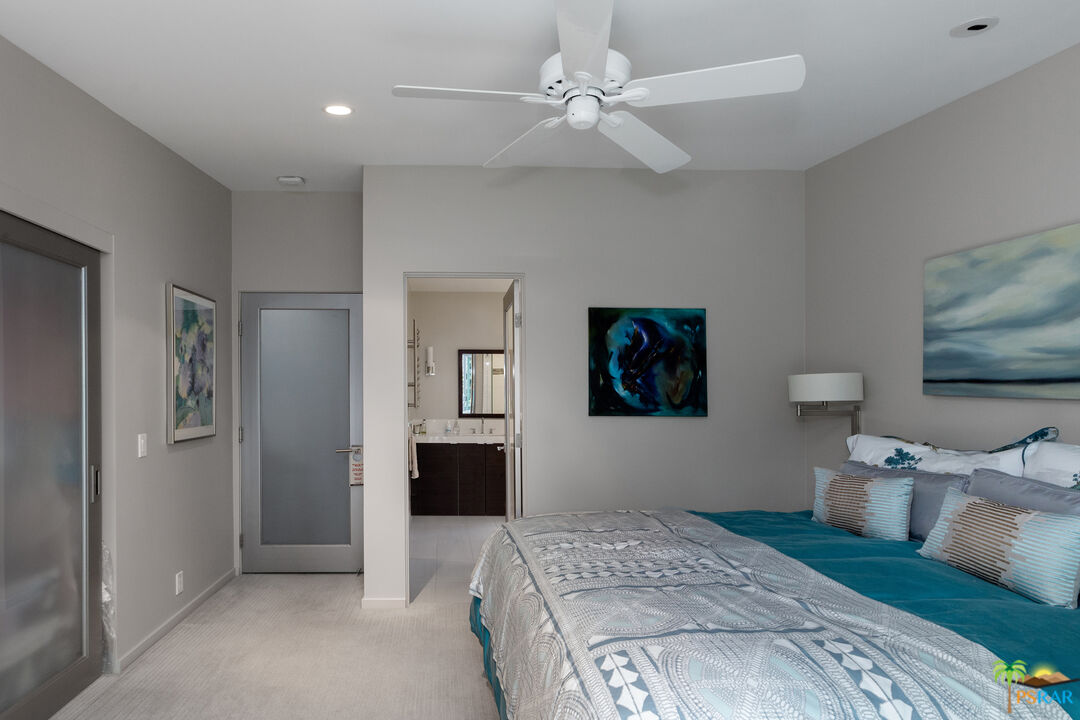 646 East Morongo Road Palm Springs, CA 92264 - Photo 18 of 45 a bedroom with a large bed and a chandelier