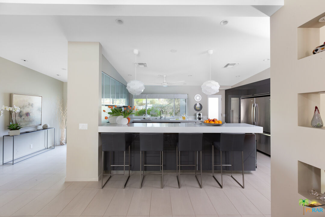 646 East Morongo Road Palm Springs, CA 92264 - Photo 6 of 45 a dining hall with stainless steel appliances kitchen island a table and chairs in it