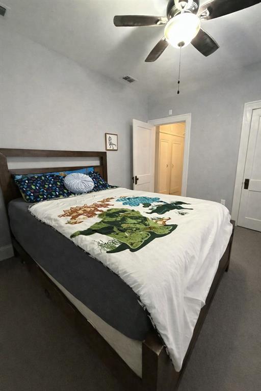 2912 10th Street Wichita Falls, TX 76309 - Photo 11 of 16 a bedroom with a bed and a chandelier