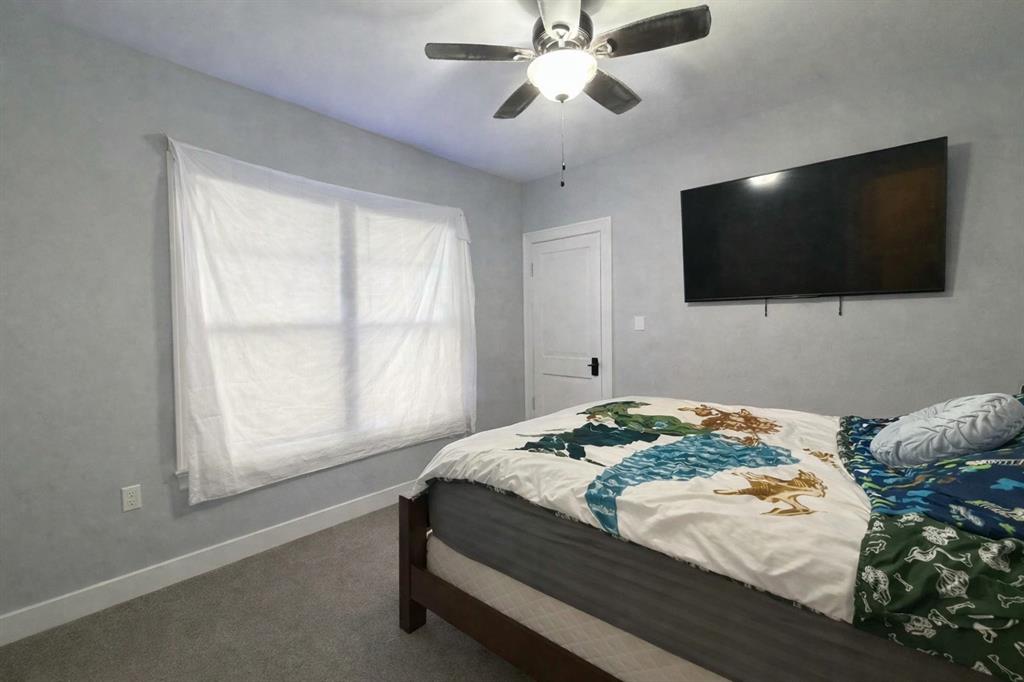 2912 10th Street Wichita Falls, TX 76309 - Photo 12 of 16 a bedroom with a bed and a flat screen tv