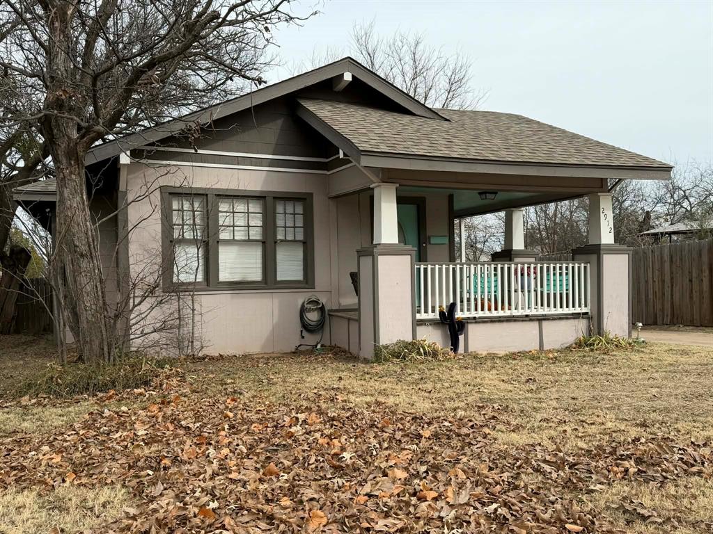 2912 10th Street Wichita Falls, TX 76309 - Photo 2 of 16 a front view of a house with a yard
