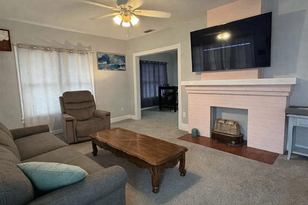 2912 10th Street Wichita Falls, TX 76309 - Photo 5 of 16 a living room with furniture and a fireplace