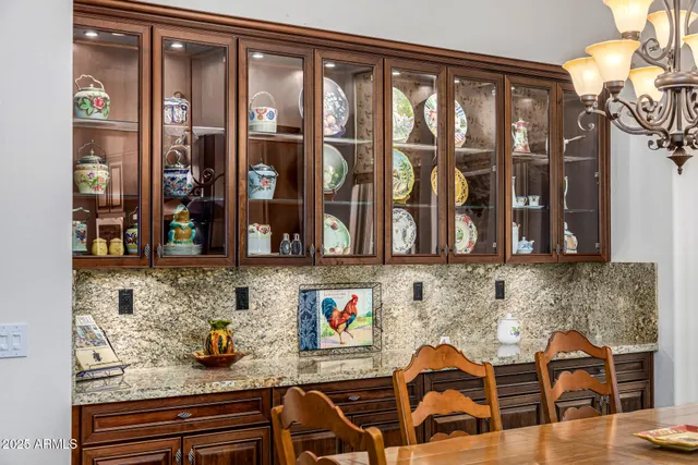 a view of the patio with a table and chairs under an umbrella