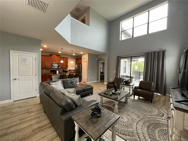 a living room with furniture and wooden floor