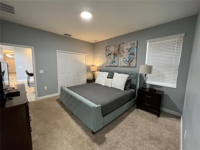 a bedroom with a bed and a couch