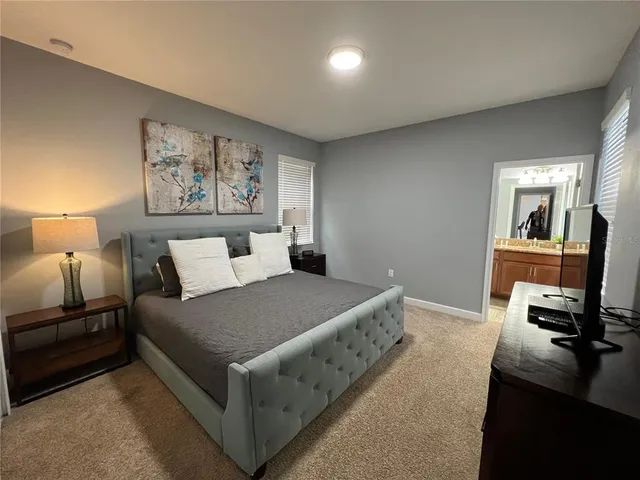 a bedroom with a bed and a couch