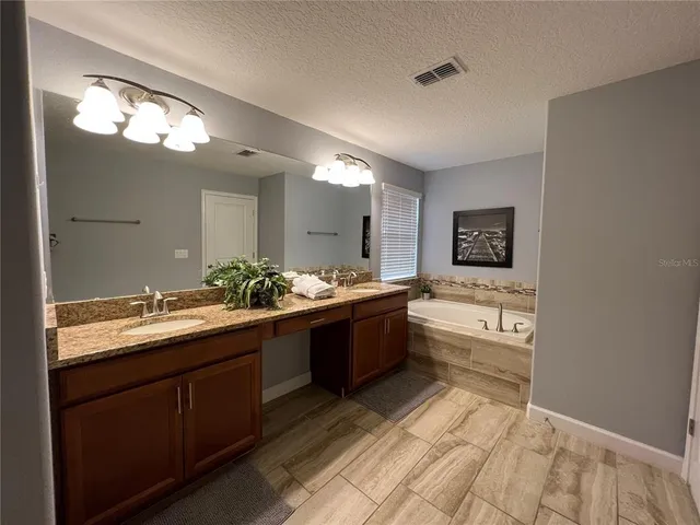 a large bathroom with a sink and a large mirror