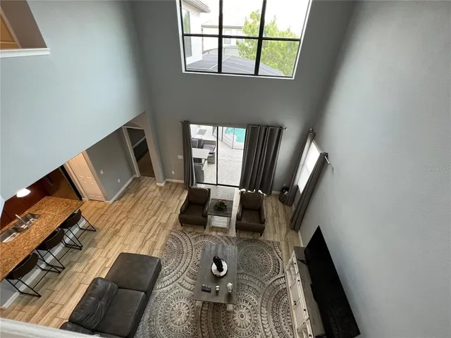 a view of a workspace with furniture and a window