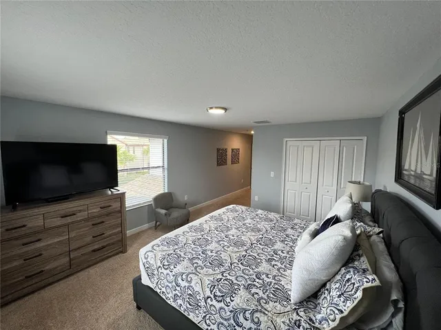 a view of a bedroom with furniture and staircase