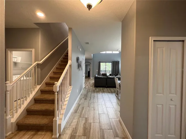 a view of a hallway view with wooden floor and staircase