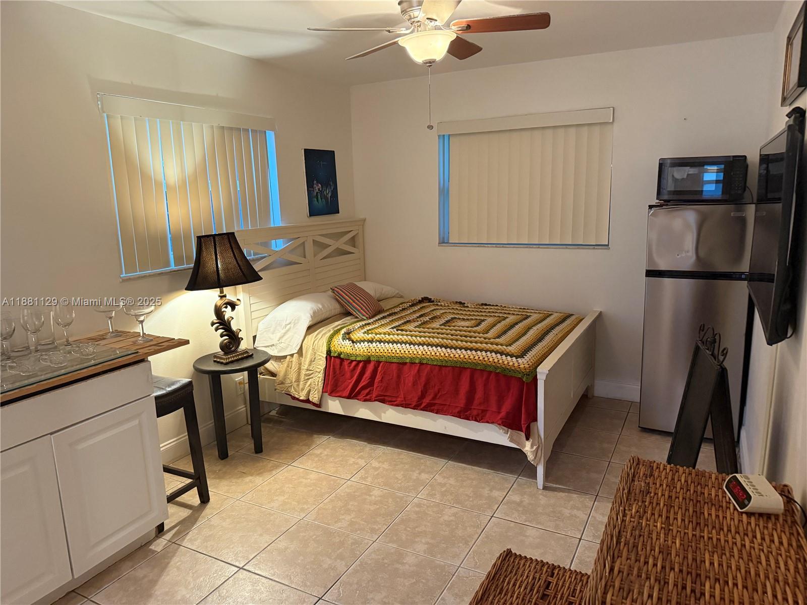 2452 Madison Street, Unit B Hollywood, FL 33020 - Photo 2 of 4 a bed room with a bed and a television