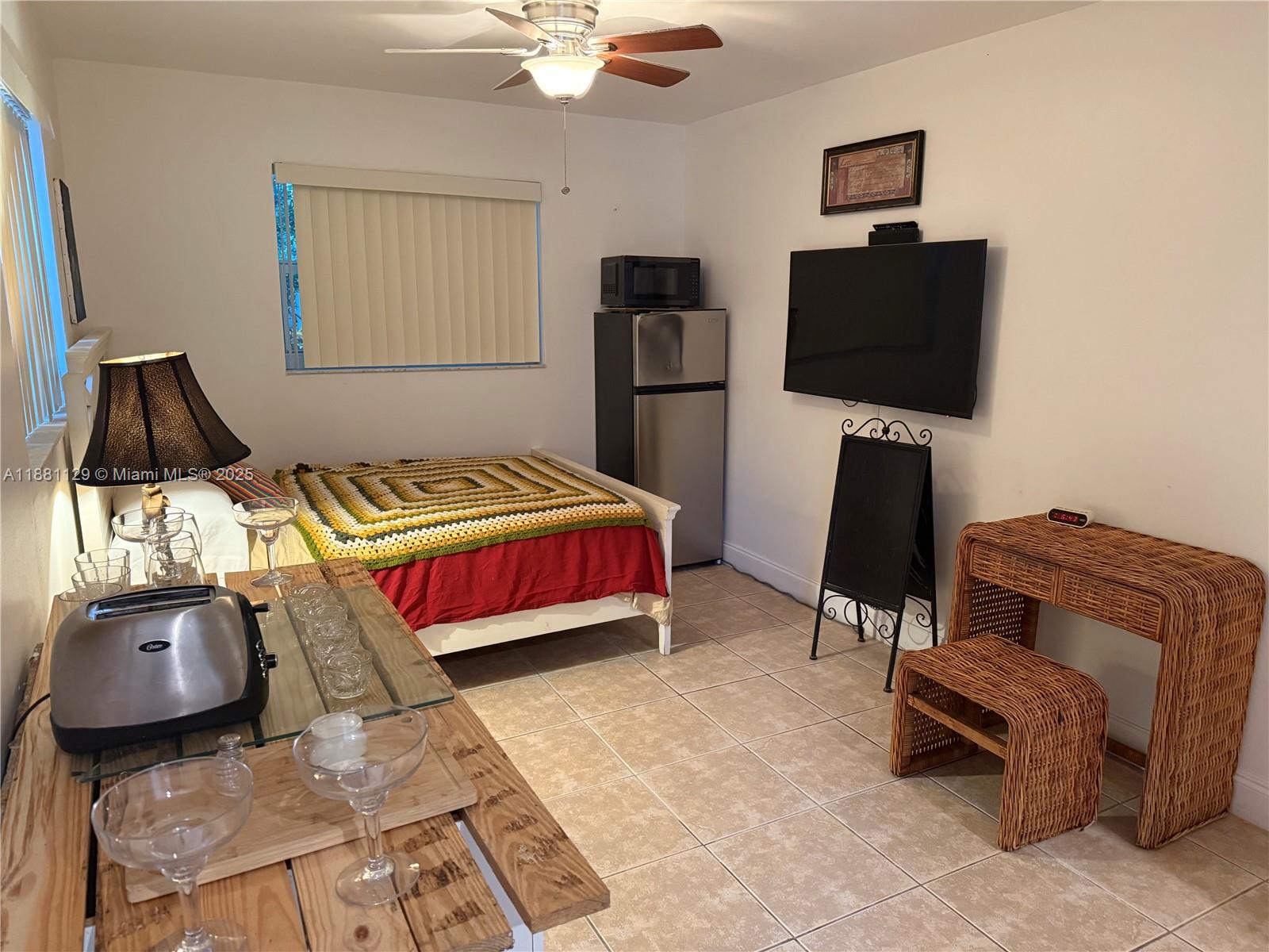 2452 Madison Street, Unit B Hollywood, FL 33020 - Photo 3 of 4 a bedroom with a bed and flat screen tv