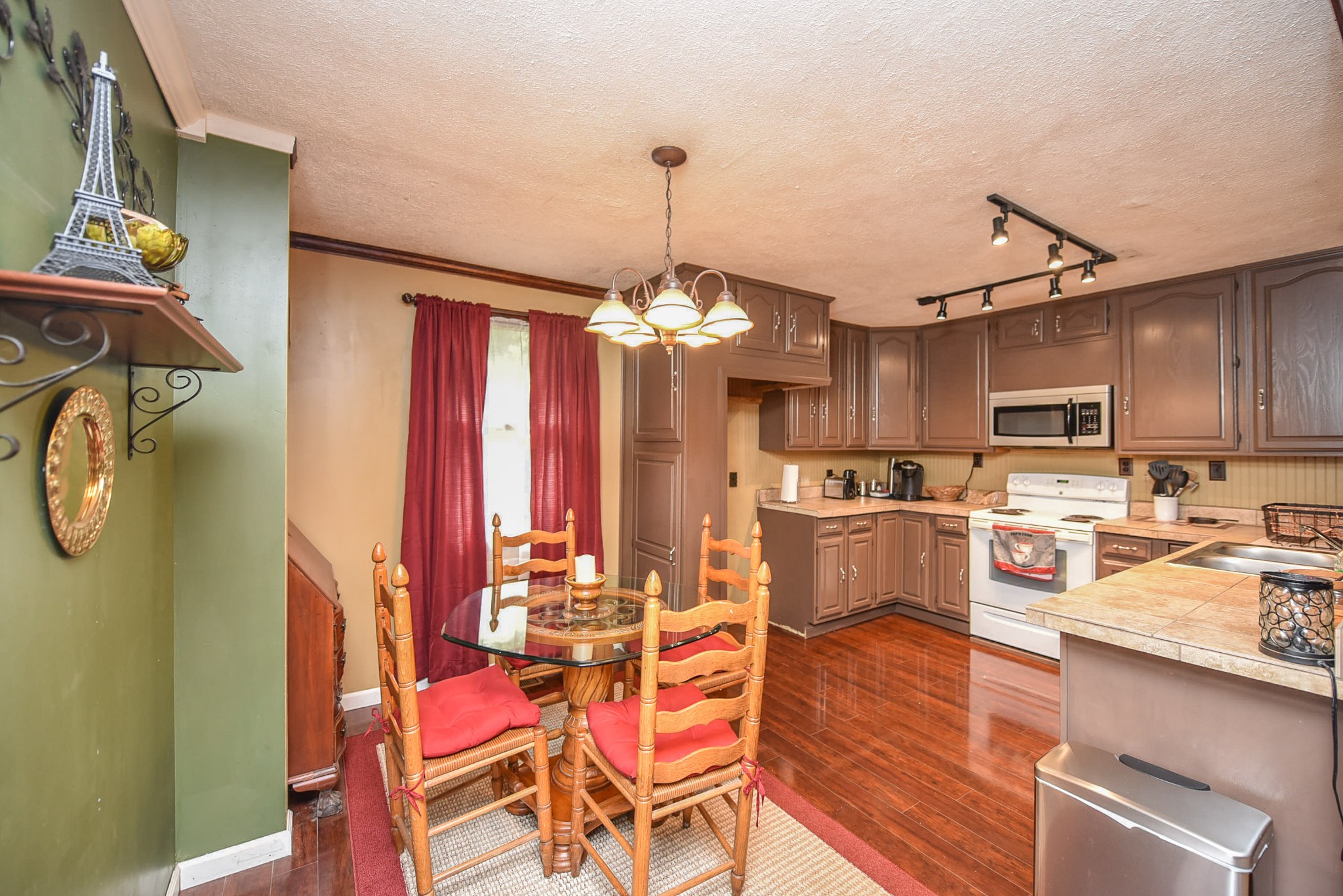 4601 Kinneys Road Springfield, TN 37172 - Photo 20 of 30 a kitchen with a refrigerator a stove cabinets and wooden floor