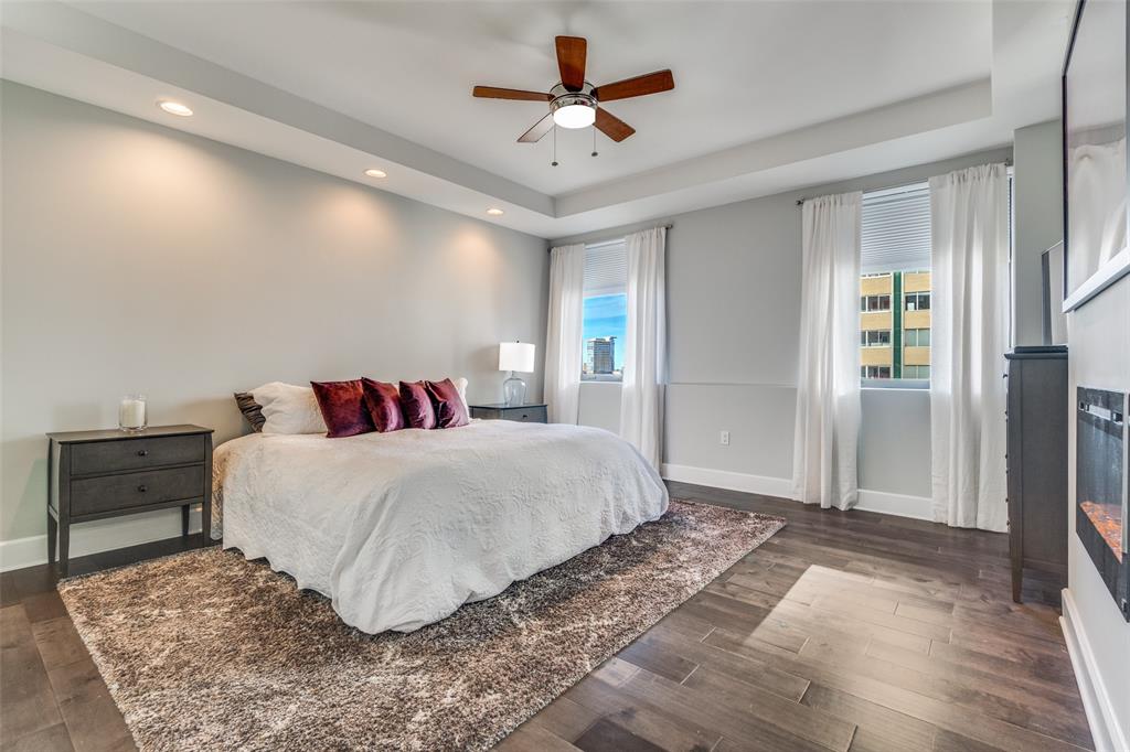 1505 Elm Street, Unit 1504 Dallas, TX 75201 - Photo 15 of 33 Bedroom featuring a raised ceiling, dark wood-style flooring, a ceiling fan, and recessed lighting